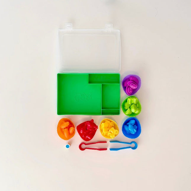 Colorful animals with a green container on a light background