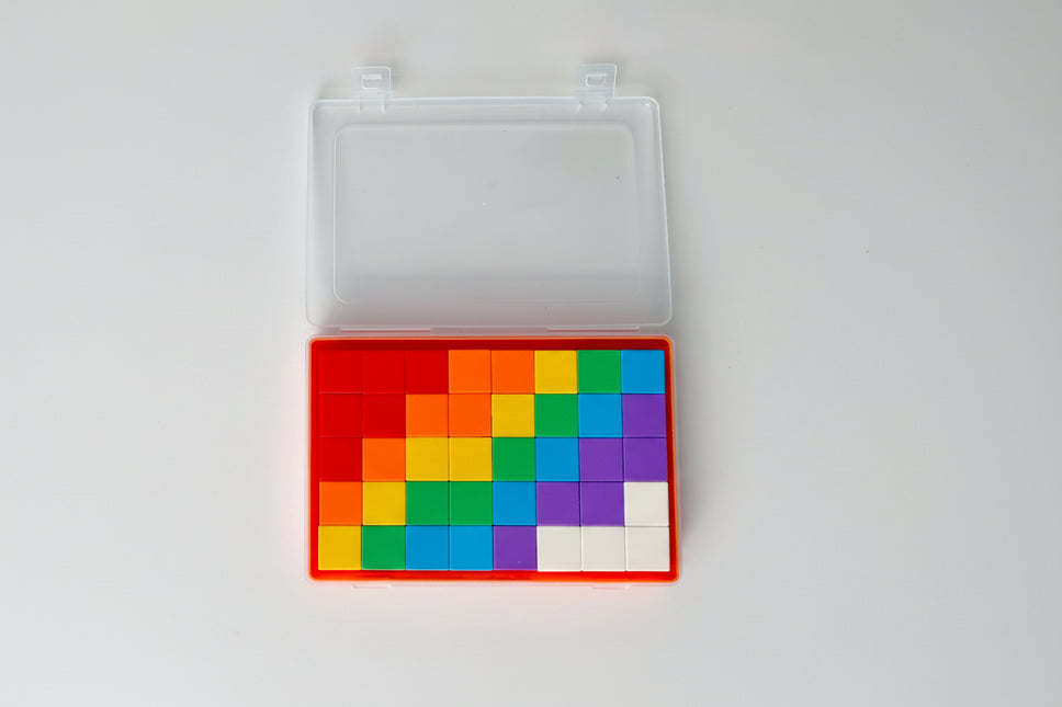 Colorful square tiles in a transparent case on a white background