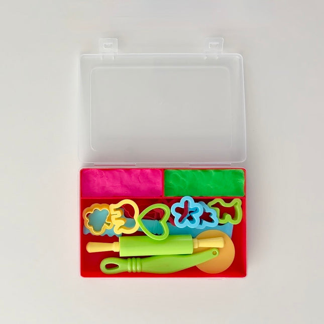Colorful dough cutters and tools in a clear plastic case on a white background